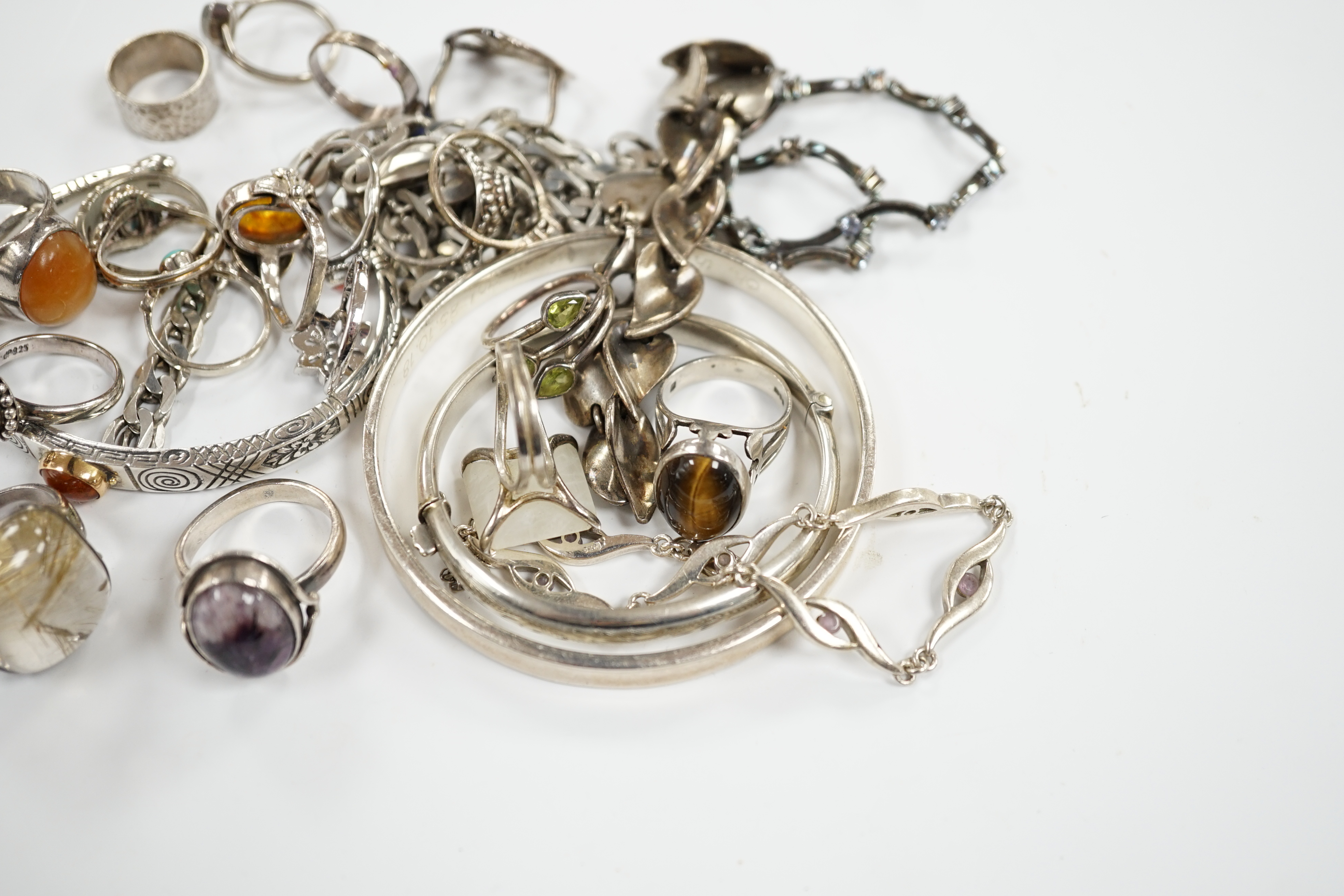 A collection of 925 and white metal rings, bangles and necklaces.